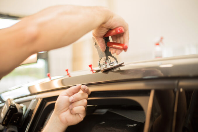 Repairing dents in a car with PDR tools